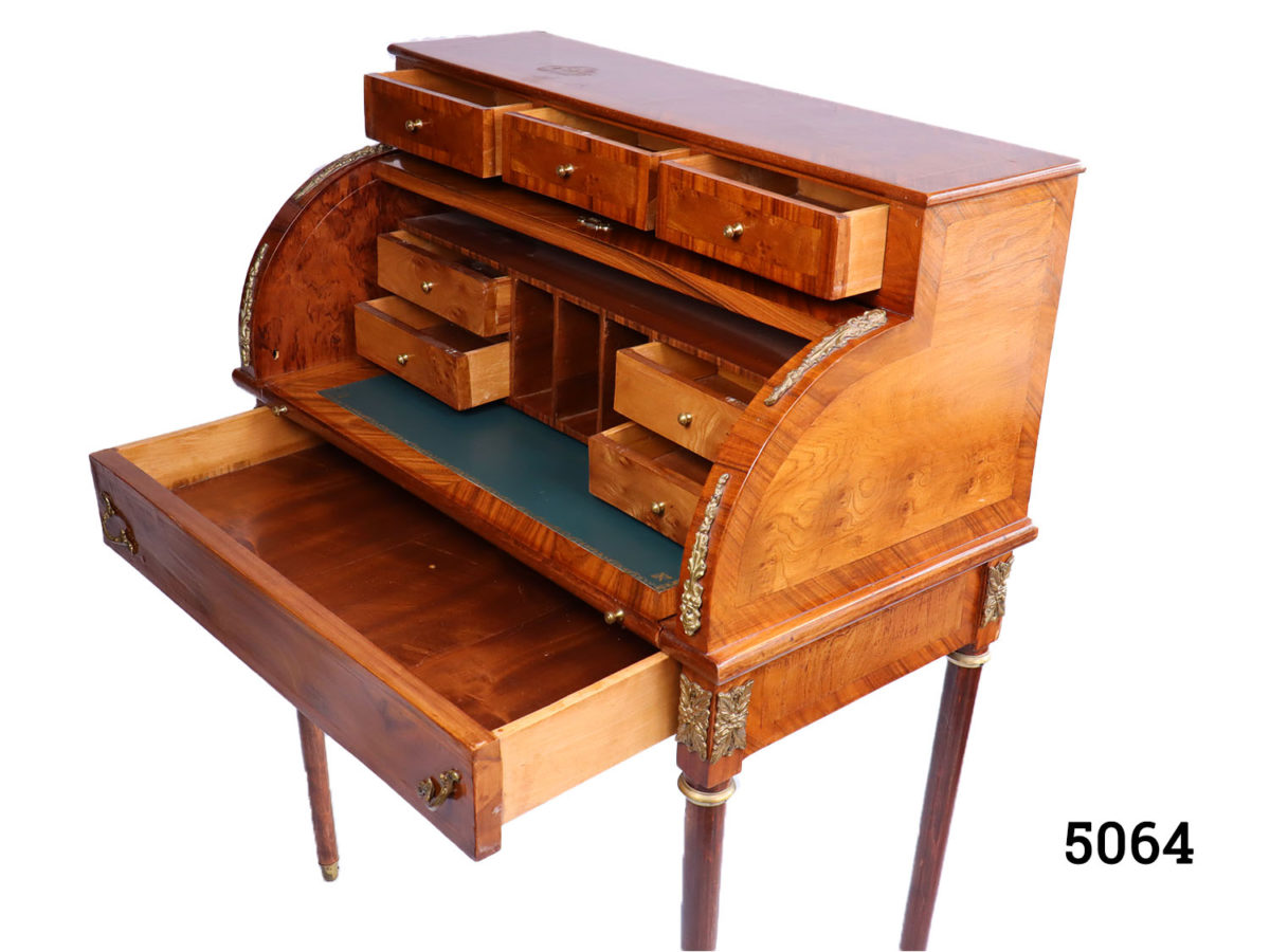 20th Century French roll top bureau decorated throughout with ormolu. Decorative key only. Photo of top half of desk showing all drawers open from a side angle