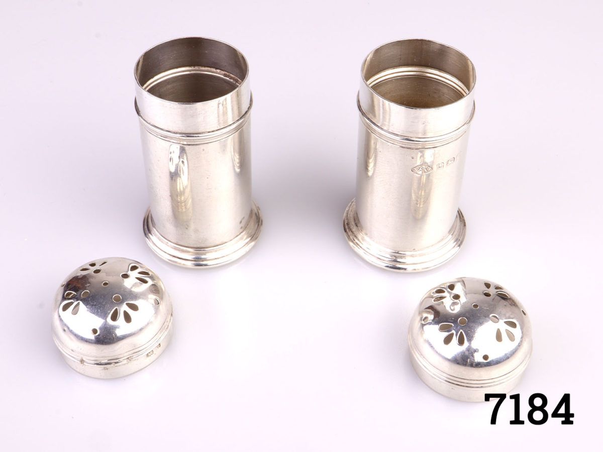 c1922 Birmingham assayed pair of sterling silver pepperettes by Adie Bros. Each pot measures 28mm in diameter and 55mm tall Photo of both pepperettes with lids removed partially showing the interior
