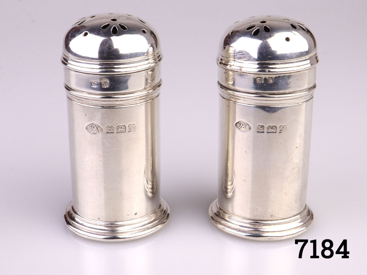 c1922 Birmingham assayed pair of sterling silver pepperettes by Adie Bros. Each pot measures 28mm in diameter and 55mm tall Main photo of both pepperettes side by side with hallmark to the fore