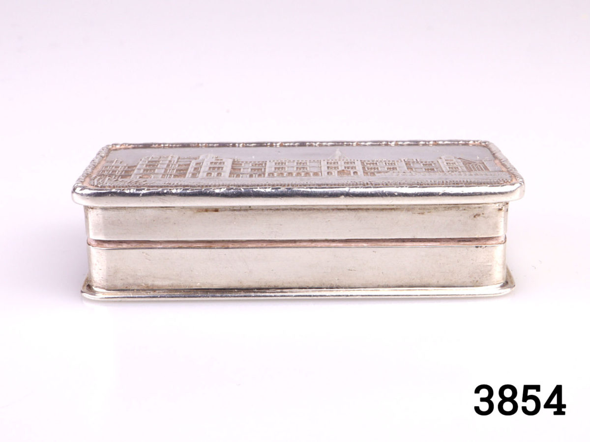 c1986 Birmingham assayed solid sterling silver pill/snuff box with gilt interior. Full hallmark on the inside (Burghley House in Lincolnshire to the lid) Side view photo of the box showing depth