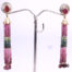 18k gold earrings with tourmaline in graduated shades of pink and green with diamonds in the top housing cover. Drop length 70mm Main photo of both earrings displayed on a stand