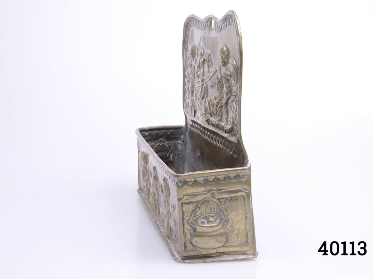 18th century Dutch brass candle box. Intricately decorated with embossed fireside scene to the base and cherubs at the top. Photo of box shown at a side angle showing depth