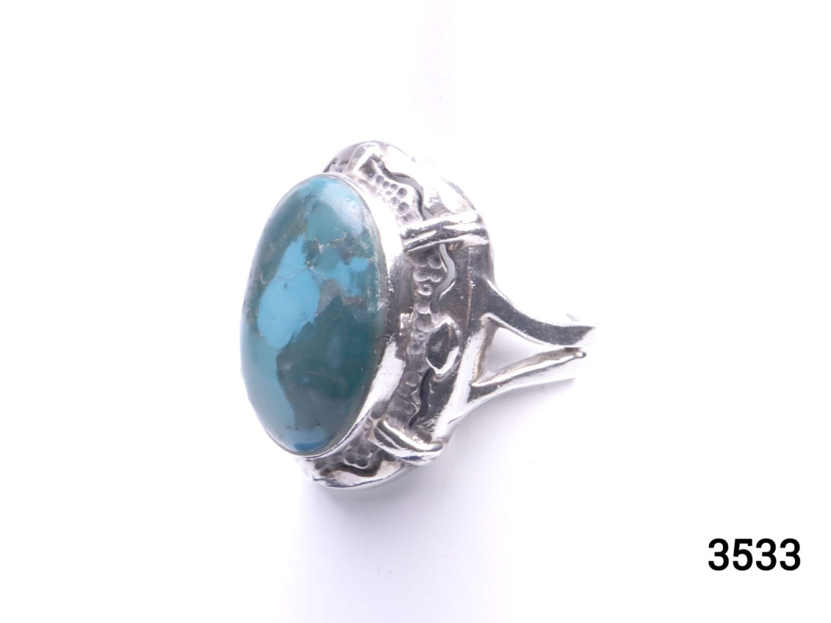 Vintage 1970s two tone turquoise stone ring. (Possibly Blue Ridge) Stone measures 18mm by 12mm. Ring size L / 5.75 Photo of ring from a side angle showing the ornate frame around the stone