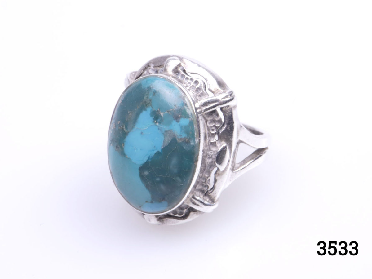 Vintage 1970s two tone turquoise stone ring. (Possibly Blue Ridge) Stone measures 18mm by 12mm. Ring size L / 5.75 Photo of ring on a flat surfaceshown at a diagonal angle