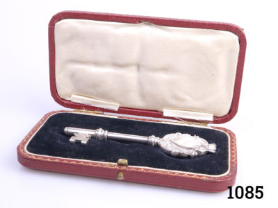 Antique sterling silver coming of age key in original case. Fully hallmarked for Birmingham assay c1901. Ornately monogrammed on one cartouche. Key measures 100mm long and 30mm wide at widest point. Key weighs 43.3grammes Main photo showing ket lying inside original case