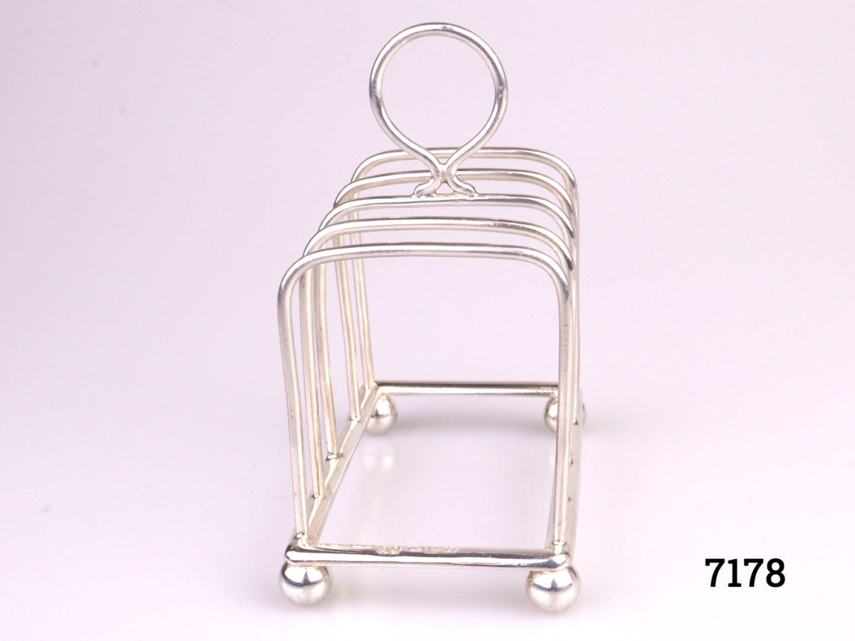 Antique sterling silver toast rack with ball feet. Fully hallmarked for Chester assay c1904 by maker J.J (Probably James Charles Jay) Photo looking at rack from front