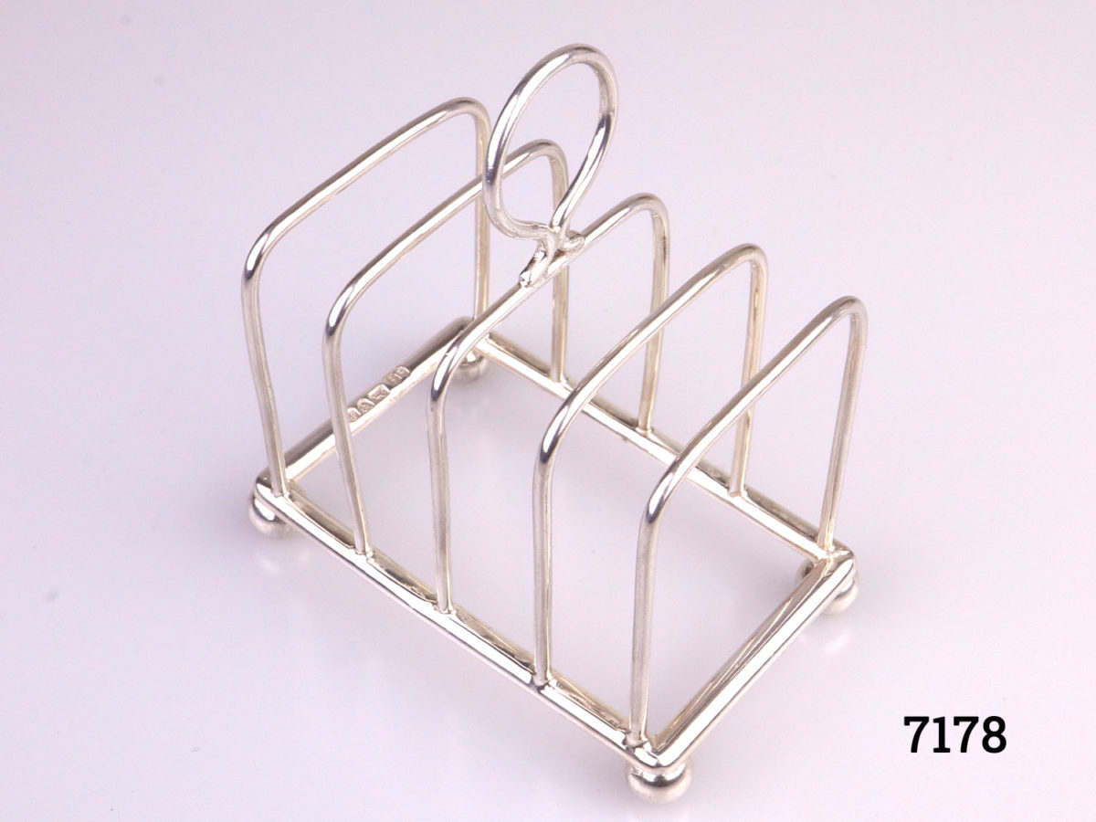 Antique sterling silver toast rack with ball feet. Fully hallmarked for Chester assay c1904 by maker J.J (Probably James Charles Jay) Photo looking down at rack