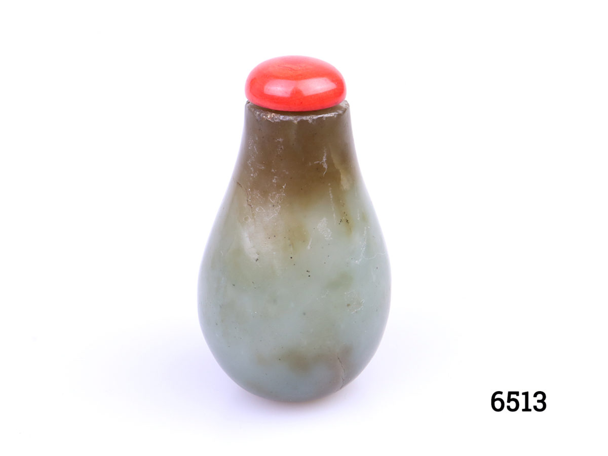 Antique 19th century snuff bottle. Green and brown colour with red lid.. Simple classic pear shape. Stands upright. Main photo showing upright bottle with red stopper in place