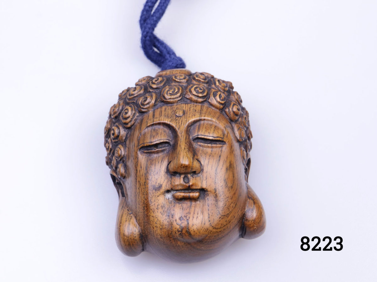 Antique Oriental inro (medicine holder). Probably Japanese. Lacquered exterior with design of an Oriental wise man looking out across bamboo grove. 3 metal lined compartments within. Signed wooden Buddha head toggle at the end and carved shell of a nut as the closing toggle. Buddha head measures 50mm long by 35mm
