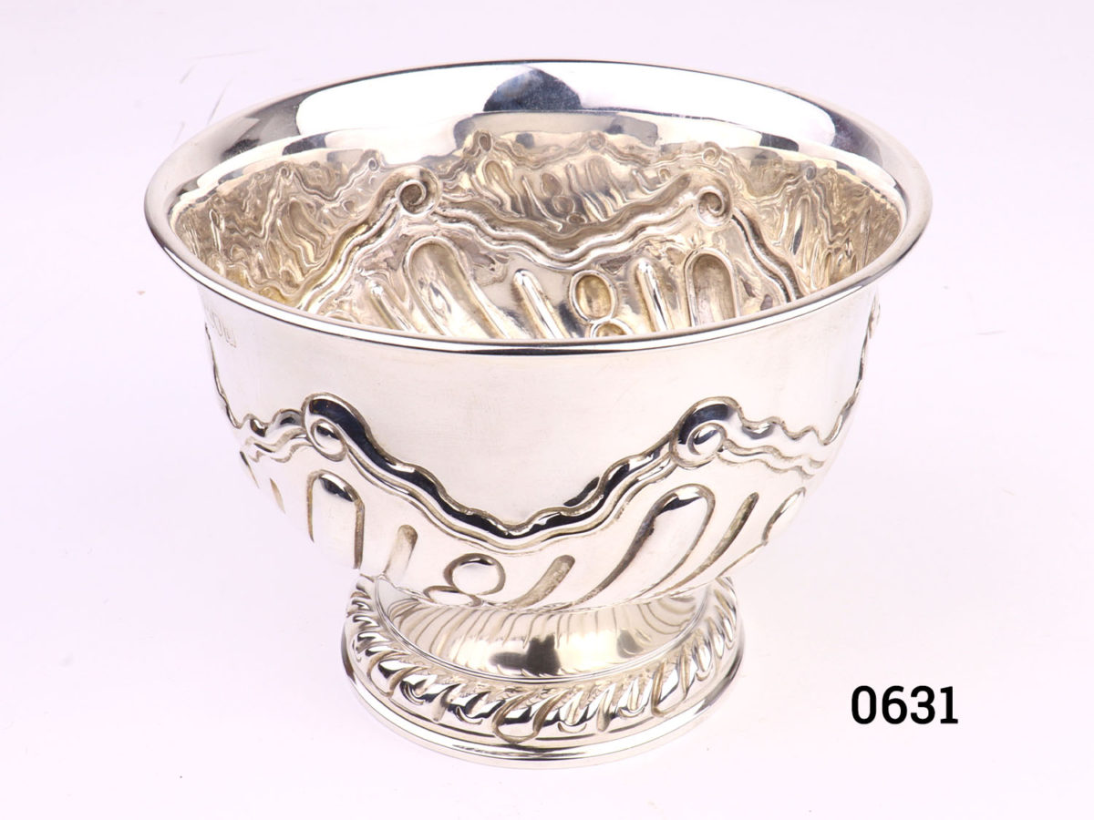 Antique sterling silver footed bowl. Fully hallmarked for London assay c1899 and made by Charles Stuart Harris. Measures 70mm in diameter at base and 115mm across the top. Photo of bowl from a slight raised angle showing partial interior