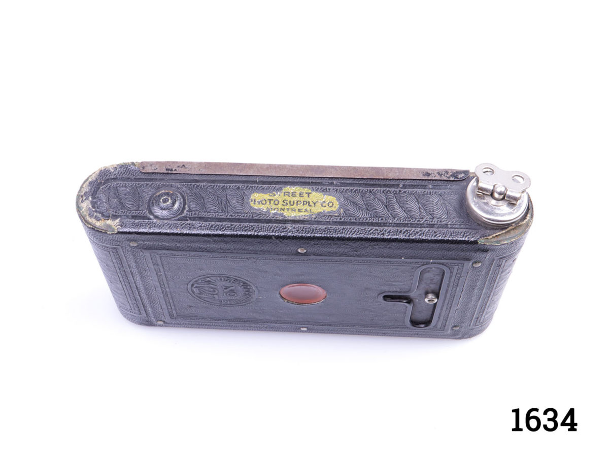 Antique Model B vest pocket Kodak camera with original case. Folding camera that fits into a vest pocket and used during the second world war. Leather pouch with initials A.E.M. on opening tab in good order but with some signs of wear. Photo of edge of camera with winder side up