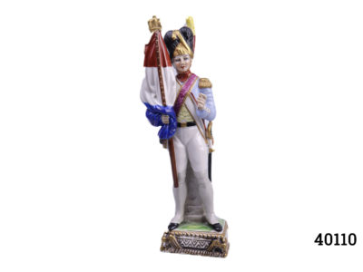Vintage Capodimonte figurine of a French military man holding the French Tricolour flag Measures 68mm by 62mm at base, 80mm at widest point and 68mm at deepest point Main photo showing military man from the front