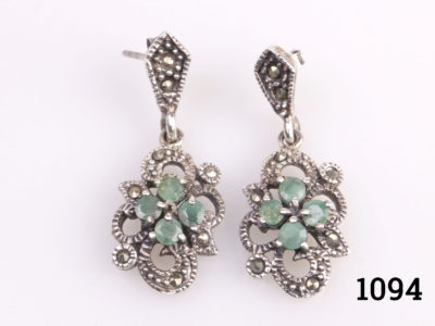 Vintage sterling silver earrings with industrial emeralds and marcasite. Drop length 32mm. Butterfly back fastening. Main photo showing both earrings laid side by side