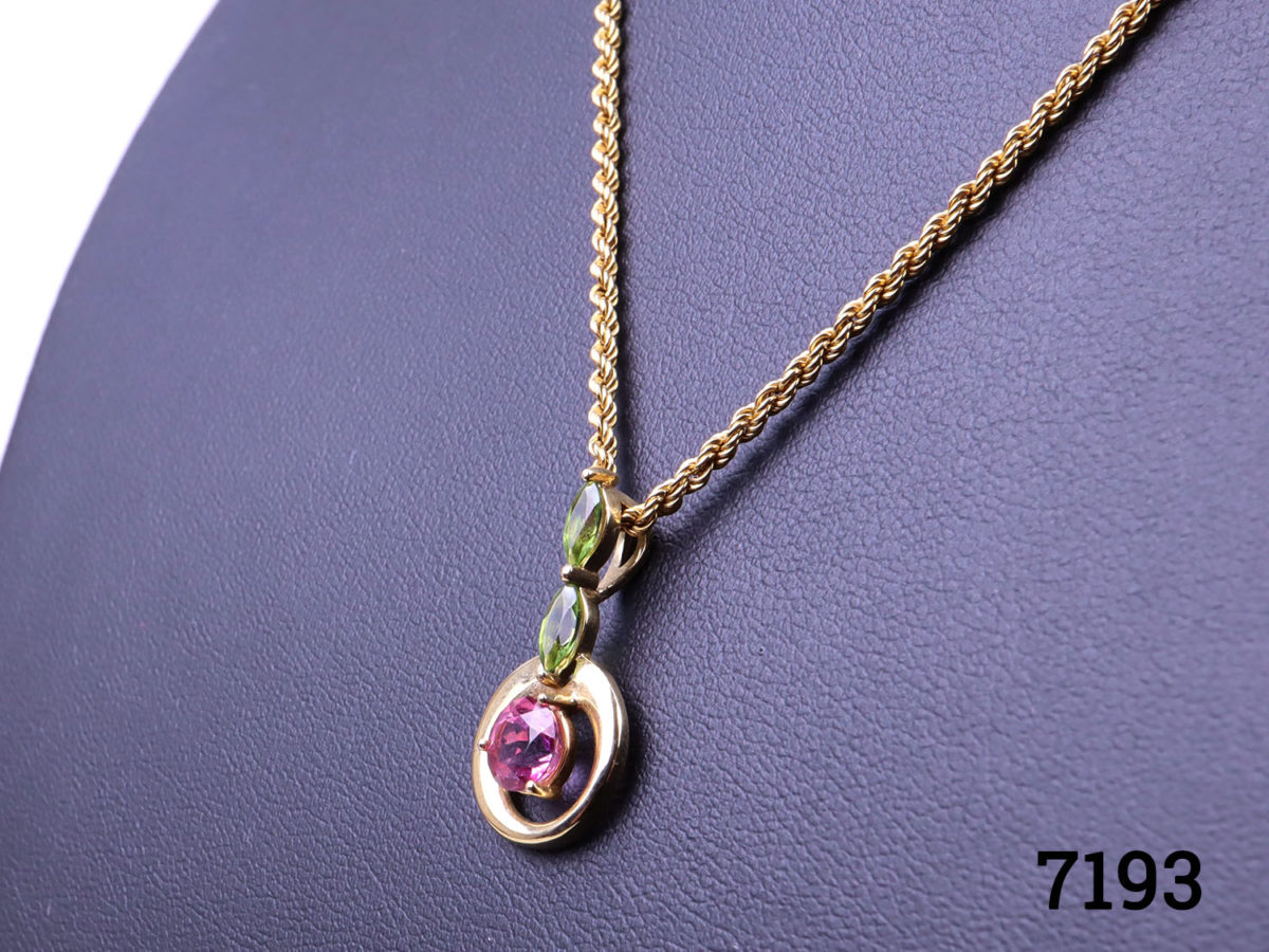 9 karat gold necklace with pink tourmaline and peridot pendant. Both necklace and pendant will full hallmarks. Pendant measures 23mm long Close up photo of the pendant seen from a slight side angle