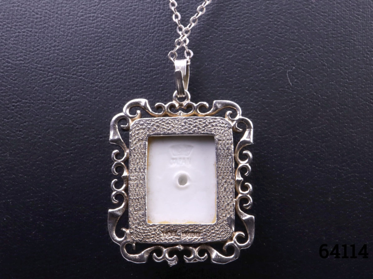 c1978 Hand-painted porcelain pendant by Toshikane of Japan mounted on a silver frame and sterling silver chain. Pendant frame fully hallmarked for Birmingham assay. Pendant measures 35mm long from top of bail to base and 25mm wide. Photo of back of pendant