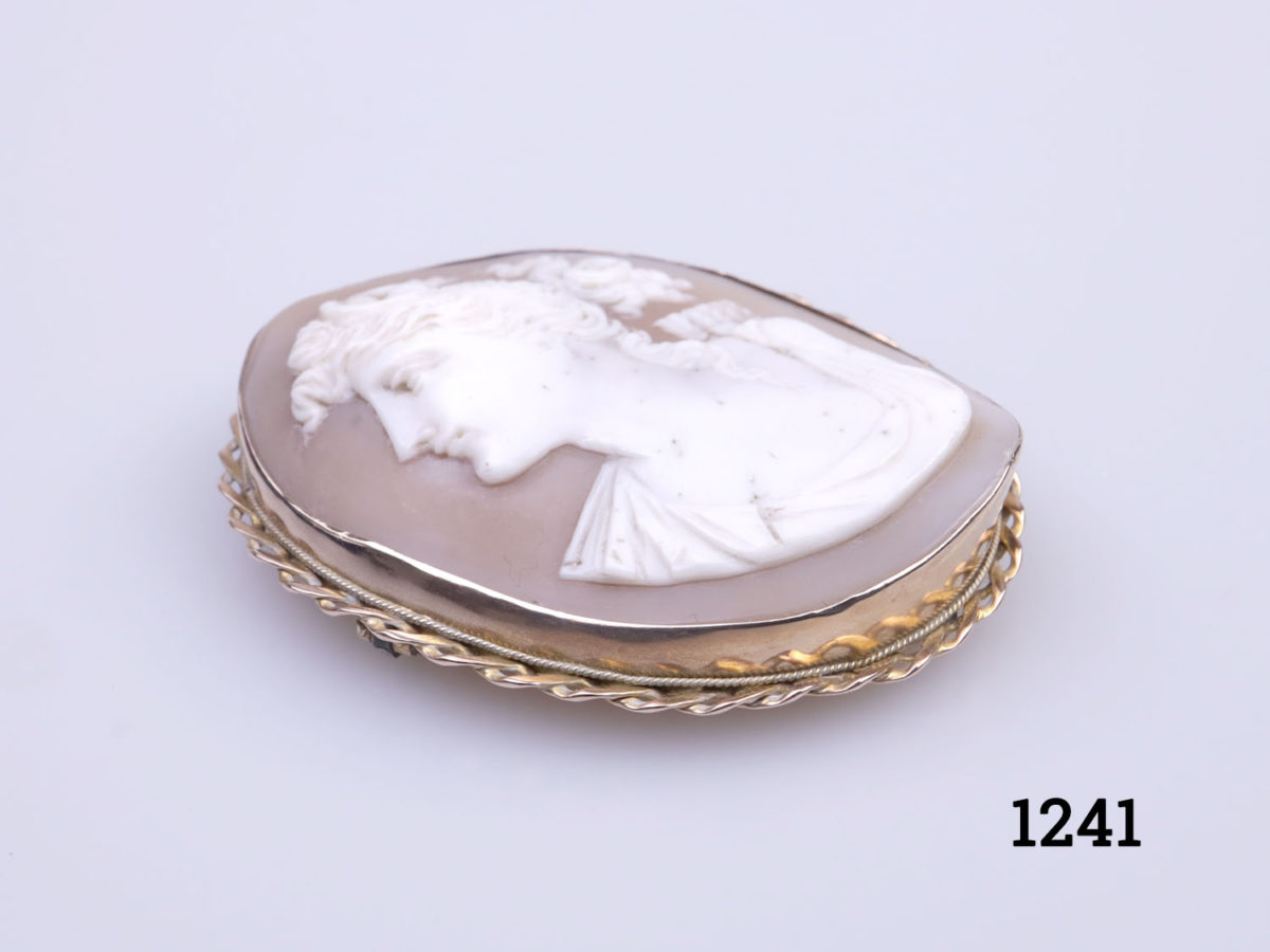Large Victorian cameo mounted on 9 karat rose gold brooch. Not hallmarked but tested for gold Photo of brooch laid diagonally with face of cameo facing left corner