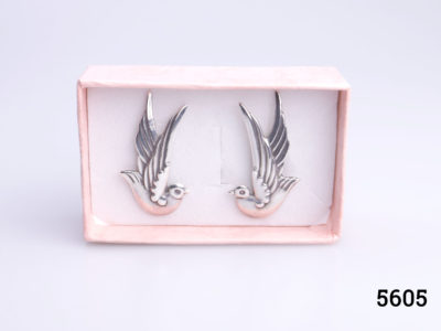Vintage Mexican silver screwback bird earrings by Taxco. To be worn with the birds wings to go up along the outer ear lobe. Each earring measures 38mm at highest point and 22mm at widest. Earrings weigh 12g Main photo of both earrings displayed inside a box showing earrings upright as would be worn on the ears