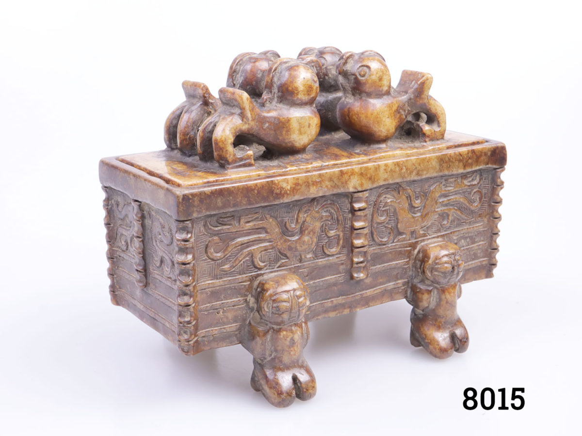 Vintage Oriental carved stone lidded casket. Decorated with 4 birds on the lid and 4 people on the base. Intricately caved bird design on each side of casket Photo of casket from a slight side angle