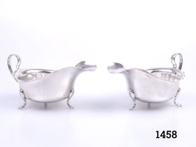 Pair of George V solid sterling silver sauce boats. Fully hallmarked for Birmingham assay c1934 and made by Barker Brothers Ltd. Each boat measures 145mm long, 88mm wide and 75mm tall Main photo of the 2 boats side by side with spouts to the centre
