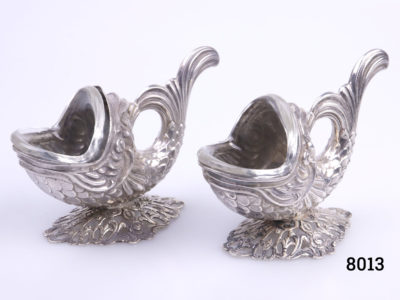 Vintage pair of fish shaped salts with clear glass liners. Hallmarked 835 silver to the base. Each fish measures 95mm at longest point (tail to mouth) 65mm tall at highest point at tail and 44 mm wide Main photo of both salts side by side