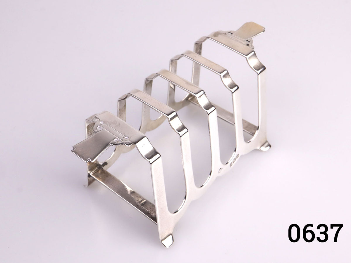 Pair of Art Deco sterling silver toast racks. Fully hallmarked for c1938 Birmingham assay. Each measures 112mm long across the top 50mm at widest point and 52mm tall. Photo of one rack looking down from above