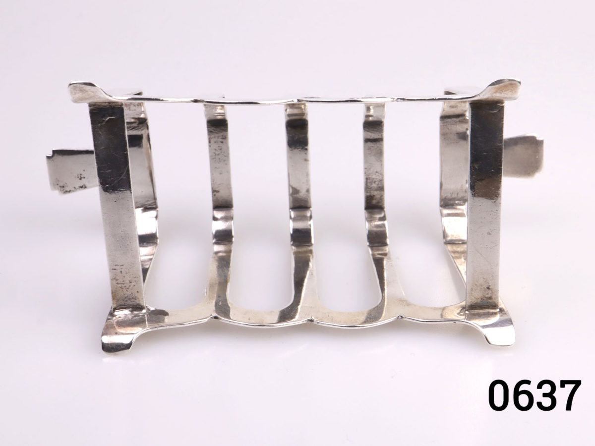 Pair of Art Deco sterling silver toast racks. Fully hallmarked for c1938 Birmingham assay. Each measures 112mm long across the top 50mm at widest point and 52mm tall.