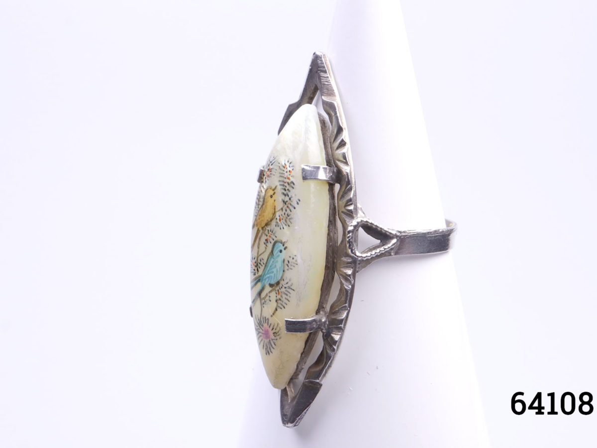 Vintage 1940s Persian 800 grade silver ring. Eye shaped mother of pearl hand-painted with 2 birds on a branch. Size M.5 / 6.5 Ring front measures 36mm long by 16mm at widest point. Photo of ring on display stand from a slight side angle
