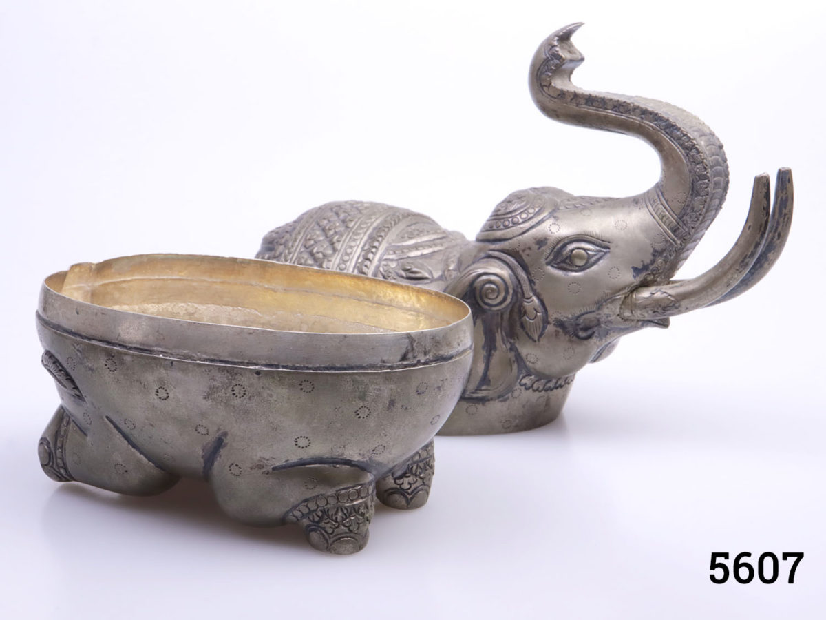 Genuine pre-1920s pair of Cambodian silver elephant condiment and mouth freshener containers. Large elephant measures 160mm at longest point, 70mm at widest and 145mm tall with hallmark of T900 to the belly Small elephant measures 85mm at longest point, 40mm at widest and 80mm tall with no visible hallmark. Photo of larger elephant with top half removed shown from side angle partially revealing the interior