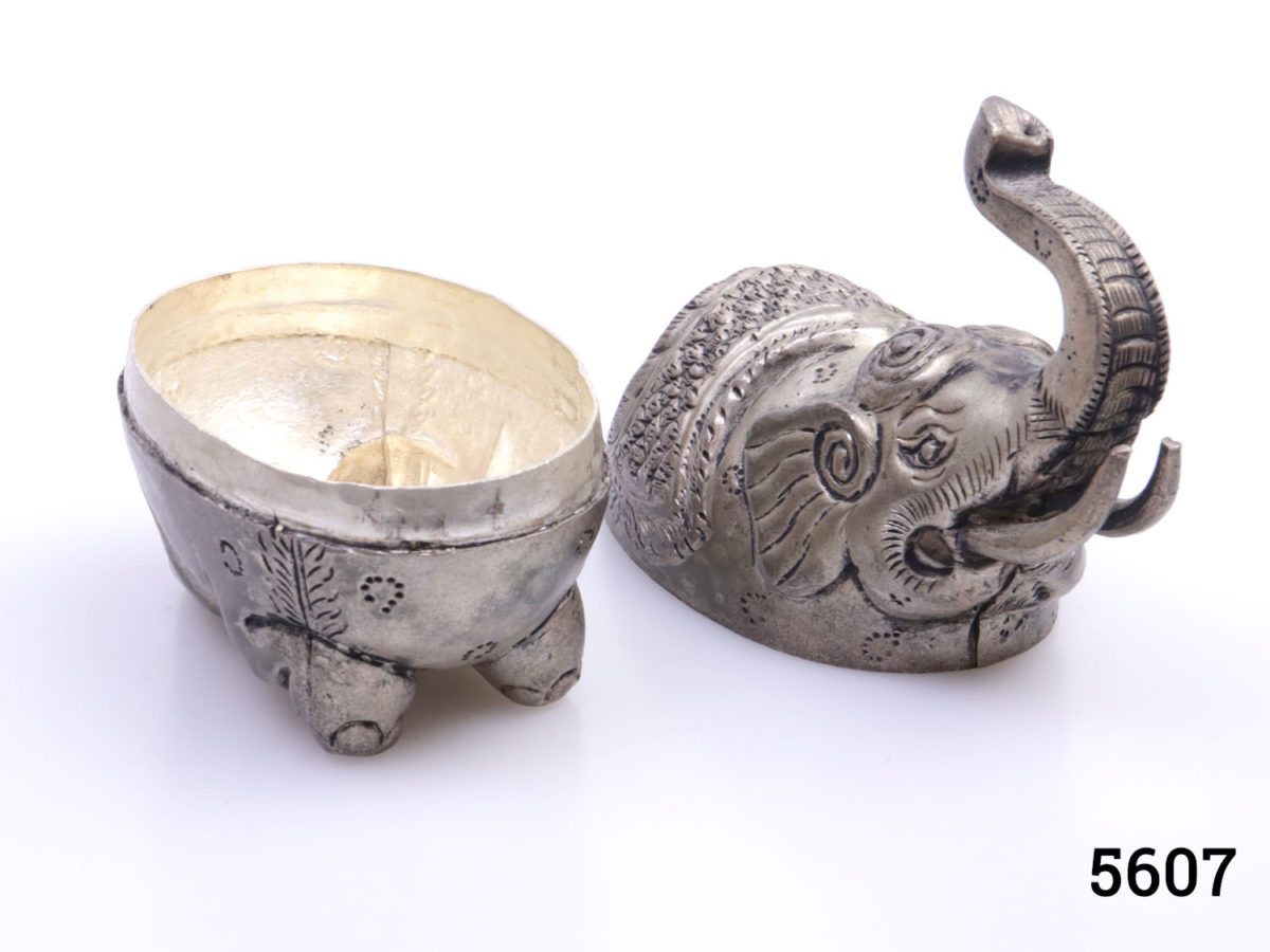 Genuine pre-1920s pair of Cambodian silver elephant condiment and mouth freshener containers. Large elephant measures 160mm at longest point, 70mm at widest and 145mm tall with hallmark of T900 to the belly Small elephant measures 85mm at longest point, 40mm at widest and 80mm tall with no visible hallmark. Photo of small elephant with lid removed showing partial interior
