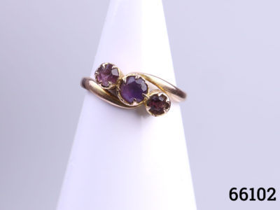 9 Karat rose gold and round cut amethyst trilogy ring. Size J / 4.75 Ring weight 1.4g Main photo of ring displayed on stand