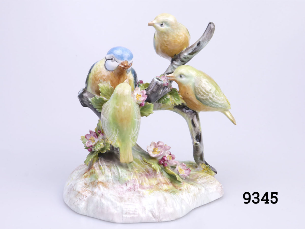 Royal Adderley bone china Blue Tit with young ornament. Colourful ornament with Blue Tit feeding its 3 young chicks. Base measures 115mm by 100mm Main photo showing ornament from front main view