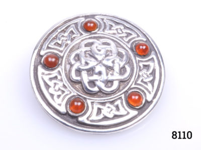 Edinburgh assayed sterling silver Celtic shield brooch with carnelian stones. Full hallmark to the back. Measures 28mm in diameter. Main photo brooch front showing Celtic design details