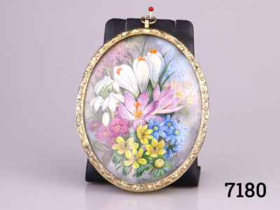 Small vintage hand-painted picture in a gilt metal oval frame. Hand-painted with spring flowers and signed M.E.R
