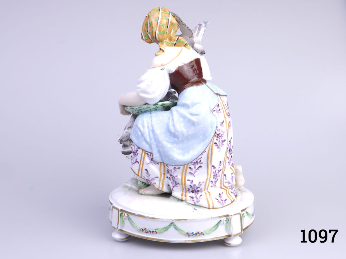 Vintage Continental porcelain figurine of a young lady feeding pigeons from a basket. No makers mark but numbered 1715 to base. Possibly German. (Some gilt wear to the base) Photo of back of ornament