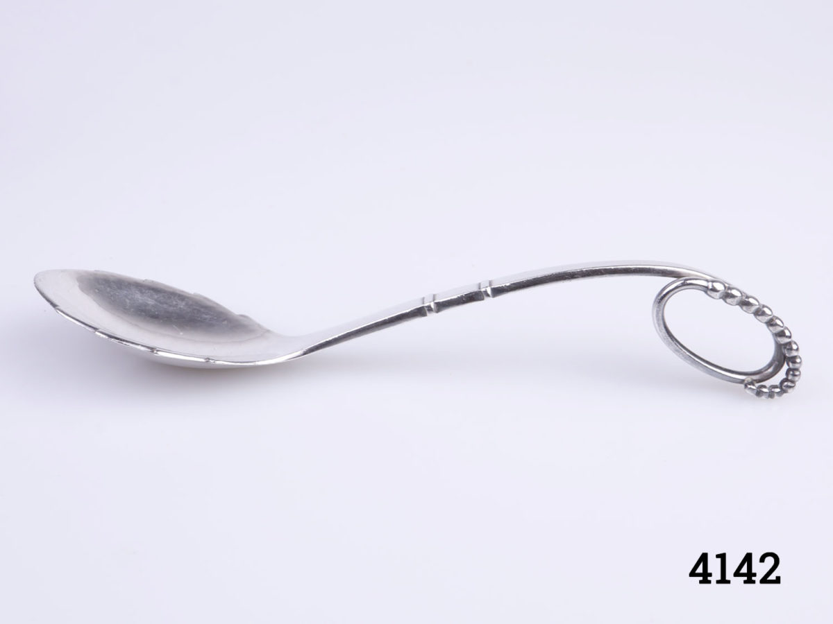 Vintage stylised sterling silver spoon by Georg Jensen c1930-45. Spoon bowl measures 38mm long by 35mm Main photo of the spoon from a side angle showing the ornate shape