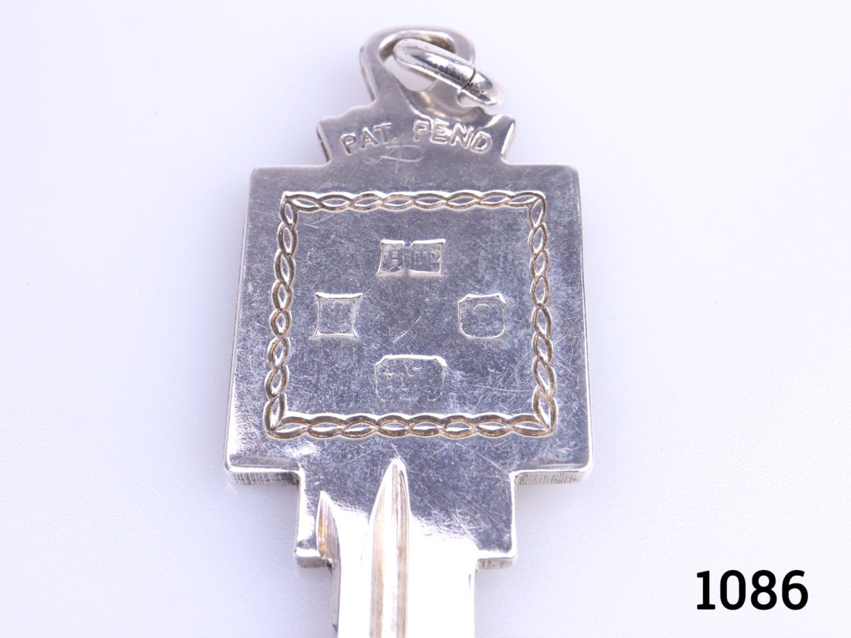 Vintage sterling silver coming of age key inscribed with 21 on one side and hallmark on the reverse. Fully hallmarked for Birmingham assay c1978 Close up photo of the hallmark side of key end