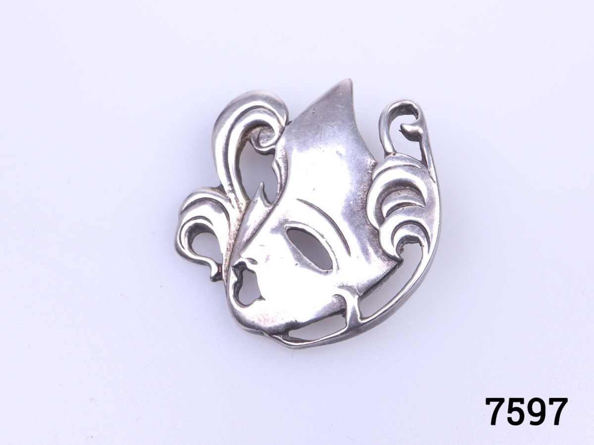 Vintage silver Art Deco style mask brooch. Full hallmark on back for Sheffield assay c1990 Photo of brooch from a slight side angle