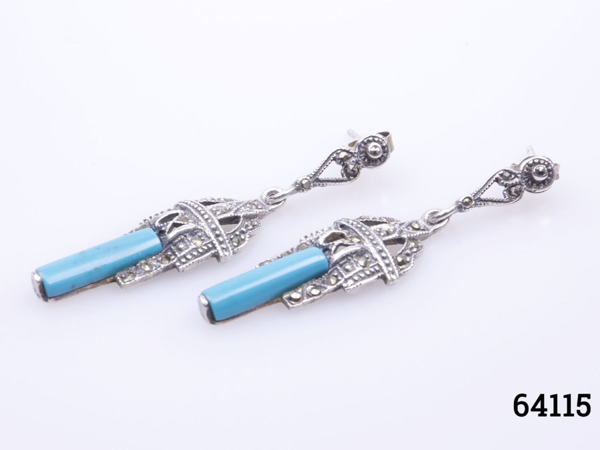 Vintage sterling silver earrings with turquoise and marcasite in an Art Deco style. Drop length of earrings 45mm. Earrings weight 5.7grams Photos of earrings on a flat surface lying side by side at an angle