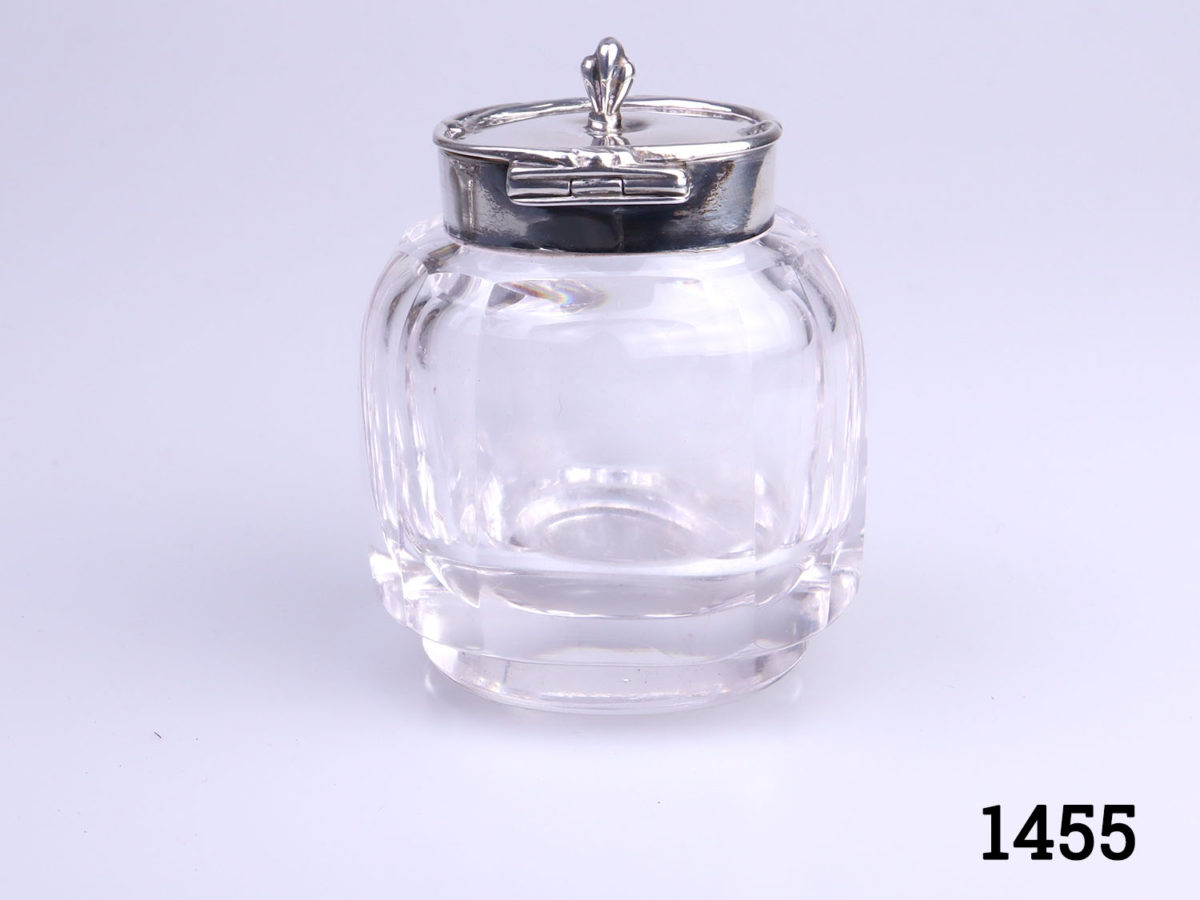 c1907 Birmingham assayed sterling silver and cut glass inkwell and stand. Inkwell sits securely in the hole in the centre of the stand. Inkwell weighs 190.6grams and measures 52mm x 45mm and 70mm tall. Stand measures 150mm long (including handles) and 110mm wide and weighs 95grams photo of inklwell from the back with lid closed showing the hnge