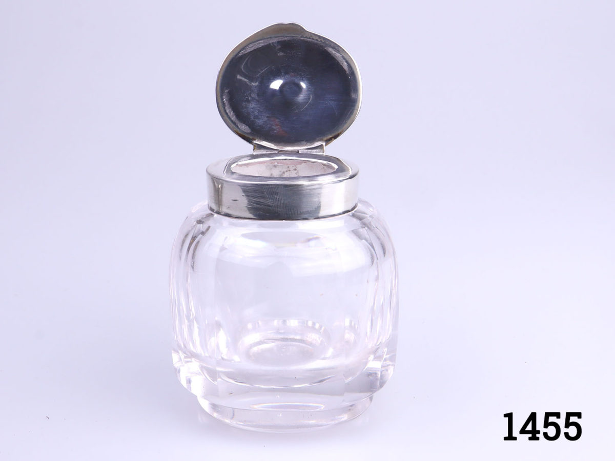 c1907 Birmingham assayed sterling silver and cut glass inkwell and stand. Inkwell sits securely in the hole in the centre of the stand. Inkwell weighs 190.6grams and measures 52mm x 45mm and 70mm tall. Stand measures 150mm long (including handles) and 110mm wide and weighs 95grams Photo of inkwell with lid open