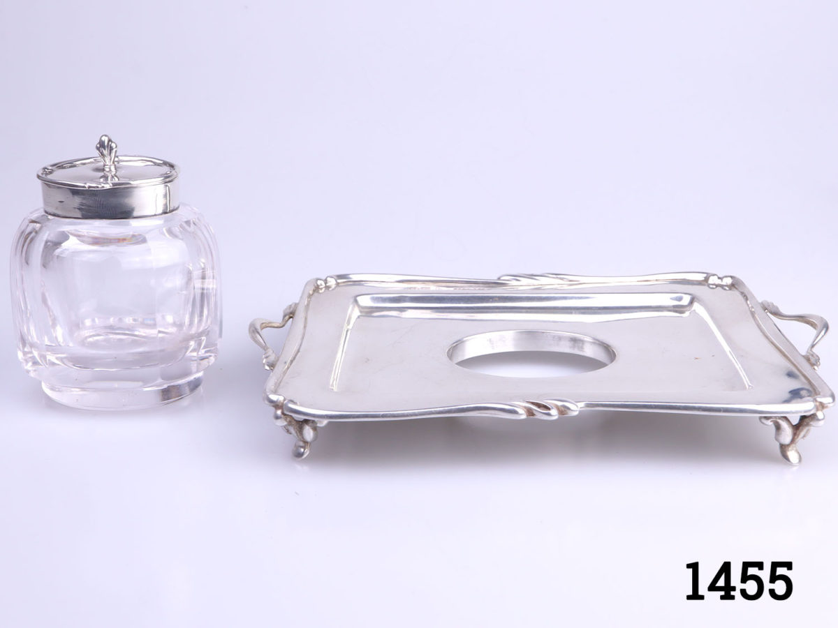 c1907 Birmingham assayed sterling silver and cut glass inkwell and stand. Inkwell sits securely in the hole in the centre of the stand. Inkwell weighs 190.6grams and measures 52mm x 45mm and 70mm tall. Stand measures 150mm long (including handles) and 110mm wide and weighs 95grams Photo of inkwell removed from tray and placed on the left side