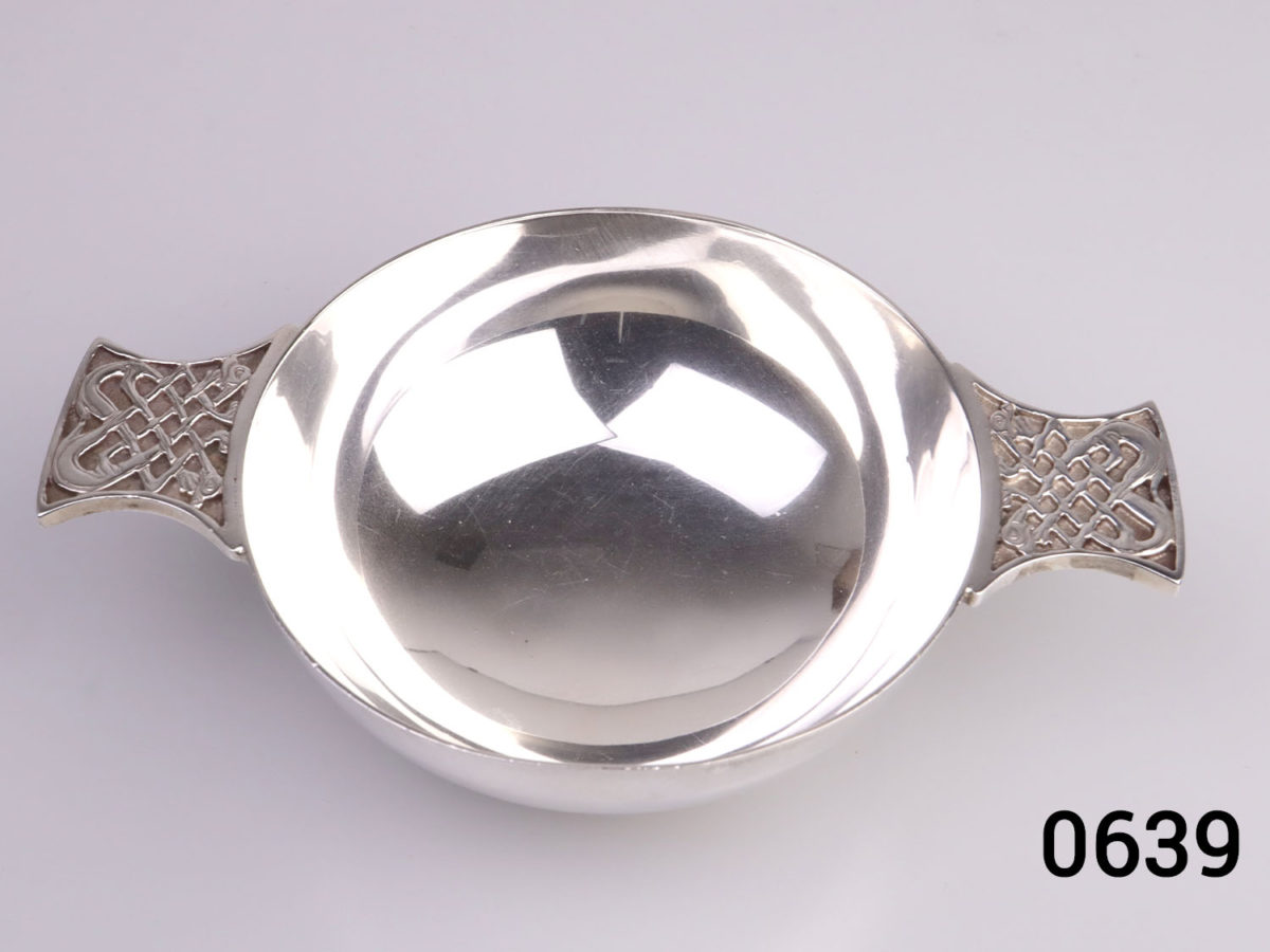 c1967 Edinburgh assayed sterling silver 2 handled Quaich drinking cup with Celtic design on the handles. Base measures 45mm in diameter. Photo looking down into cup bowl