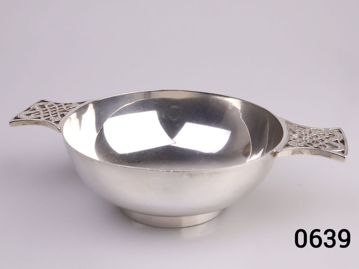 c1967 Edinburgh assayed sterling silver 2 handled Quaich drinking cup with Celtic design on the handles. Base measures 45mm in diameter. Main photo of cup with handles to left and right