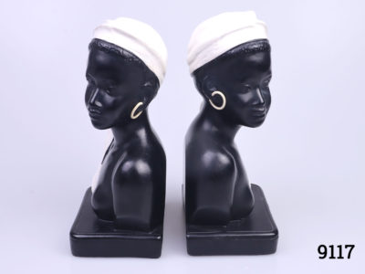 c1950s Duron bookends in the form of African ladies. Both figures looking outward with contrasting white head gear and earrings. Numbered 6010 the back with Reg No.883679 Each measures approximately 90mm long and 65mm wide Main photo of bookends back to back