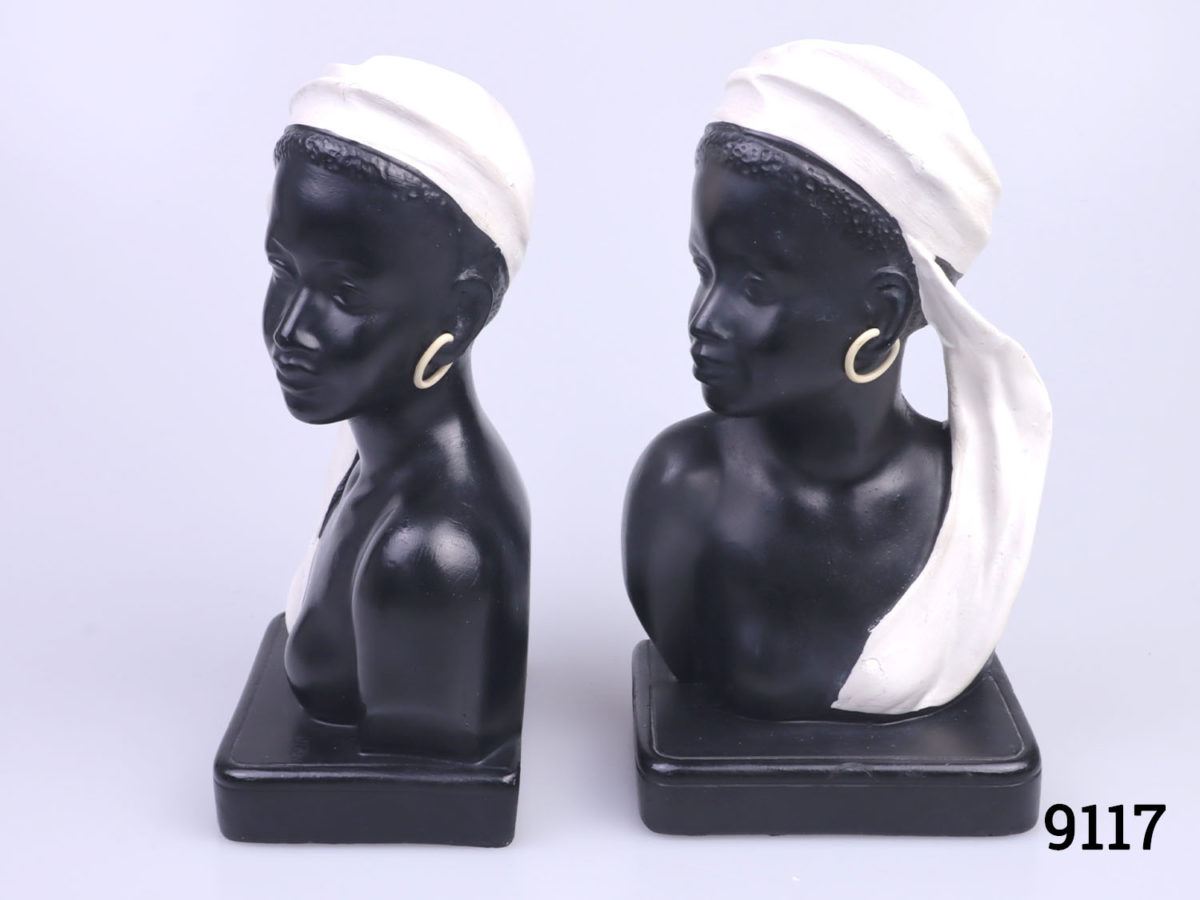 c1950s Duron bookends in the form of African ladies. Both figures looking outward with contrasting white head gear and earrings. Numbered 6010 the back with Reg No.883679 Each measures approximately 90mm long and 65mm wide Photo of both ends facing the same direction