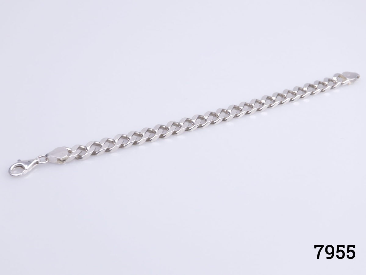 1970s solid sterling silver curb chain bracelet. Hallmarked 925 for sterling silver Photo of bracelet laid out on a flat surface