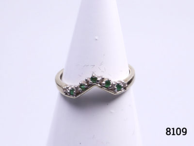 Vintage 9 karat gold ring. Wishbone shape to the front and set with 5 small emeralds and 6 small diamonds. Size P.5 / 7.75. Ring weight 1.9 Main photo showing ring front on display stand