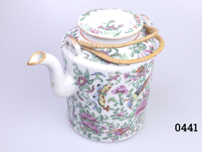 Antique Famille Rose teapot. Hand-decorated in a floral scene with birds and butterflies. (The spout tip has had a professional repair). Measures 130mm in diameter at base and 210mm tall with handle extended. Main photo of teapot with lid in place and seen from a slightly raised angle