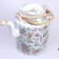 Antique Famille Rose teapot. Hand-decorated in a floral scene with birds and butterflies. (The spout tip has had a professional repair). Measures 130mm in diameter at base and 210mm tall with handle extended. Main photo of teapot with lid in place and seen from a slightly raised angle