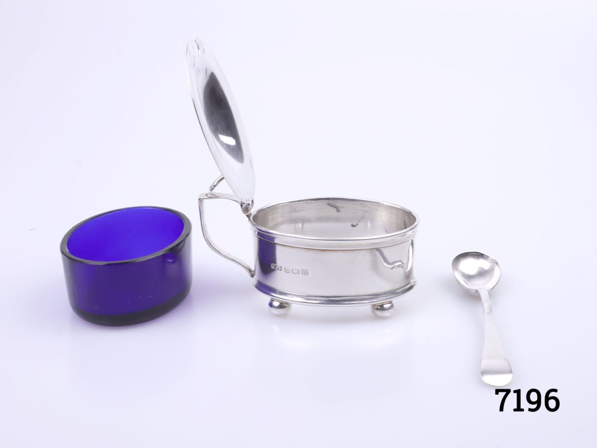 c1919 Birmingham assayed sterling silver mustard pot with Bristol blue glass liner. c1894 sterling silver spoon included. Spoon measures 82mm Photo of pot with blue liner and spoon removed and placed outside of main pot